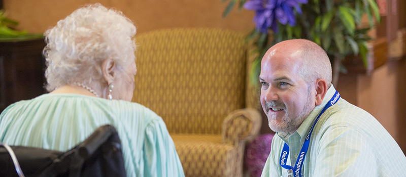 Chief Ombudsman Greg Shelley with an assisted living center resident.