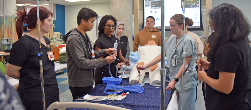 Several AGACNP students in the simulation lab learning how to administer extracorporeal membrane oxygenation.