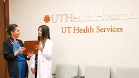 Nurse practitioner and student in UT Health Services lobby