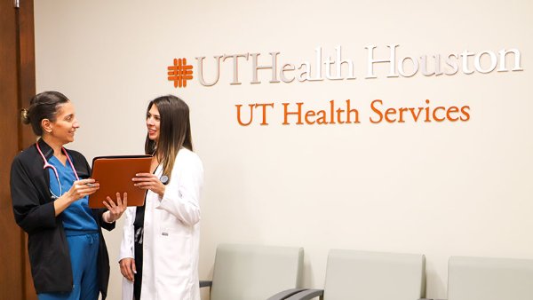 Nurse practitioner and student in UT Health Services lobby