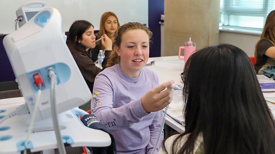 High school students visiting Cizik School of Nursing sim lab.