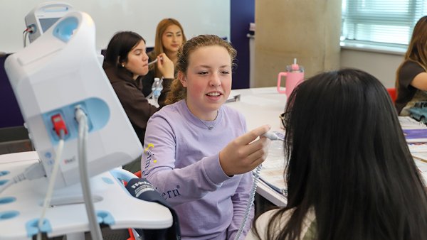 High school students visiting Cizik School of Nursing sim lab.