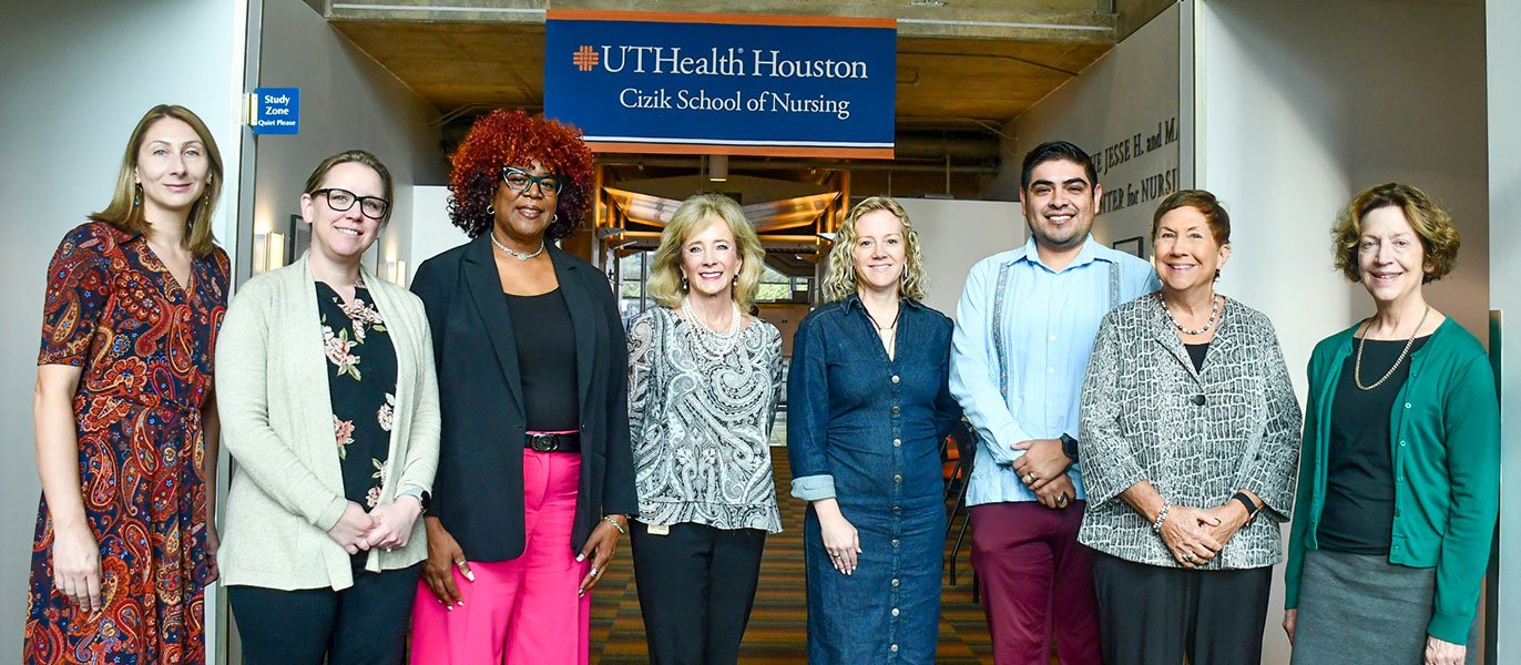 Pictured: Dr. Maja Djukic, Dr. Ansley Stanfill, Dr. Veronica Brady, Dr. Allison Edwards, Dr. Diane Santa Maria, Dr. Higinio Fernandez-Sanchez, Dr. Susan Ruppert, and Dr. Janet Van Cleave. The banner has Cizik School of Nursing logo.