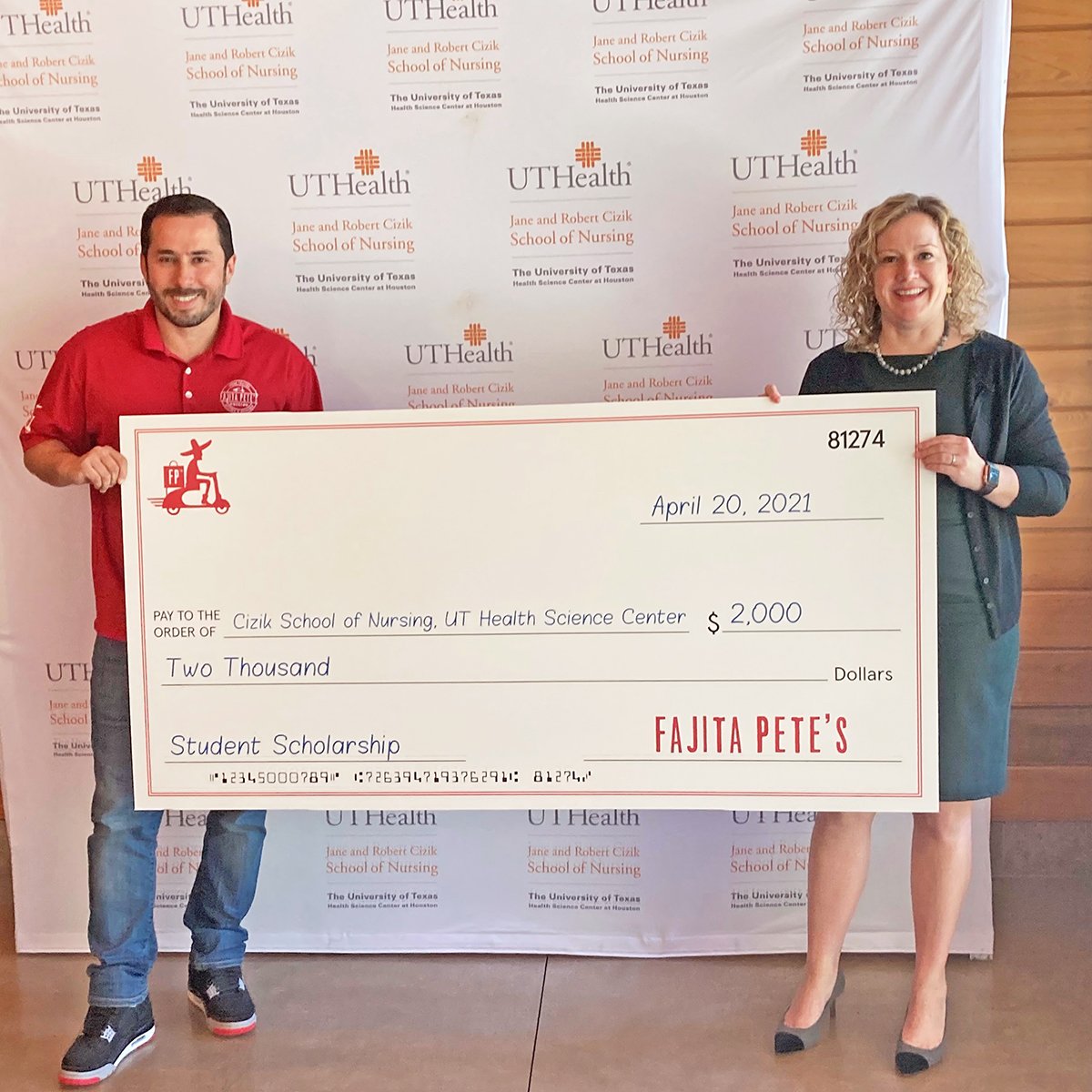 Pedro Mora presents a check to Diane Santa Maria.