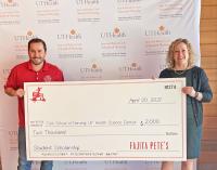 Pedro Mora presents a check to Diane Santa Maria.