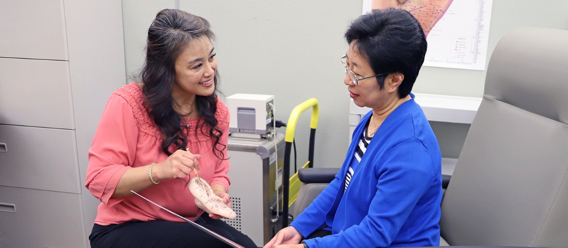 Dr. Kawi with a patient in her lab