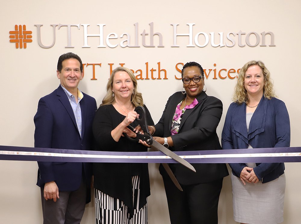 Chief Operating Officer of UT Physicians Andrew Casas, Leissa Roberts, Joy Harrison, and Cizik School of Nursing Dean Diane Santa Maria cut the ribbon on the new UT Health Services clinic.