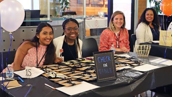 Four students at a welcome desk