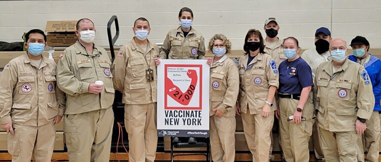 Assistant Professor Daniel Arellano, third from left, poses with other members of his DMAT at their vaccination deployment site in New York. (Photo courtesy Daniel Arellano. All pictured received same-day antigen testing and were negative for COVID-19.)