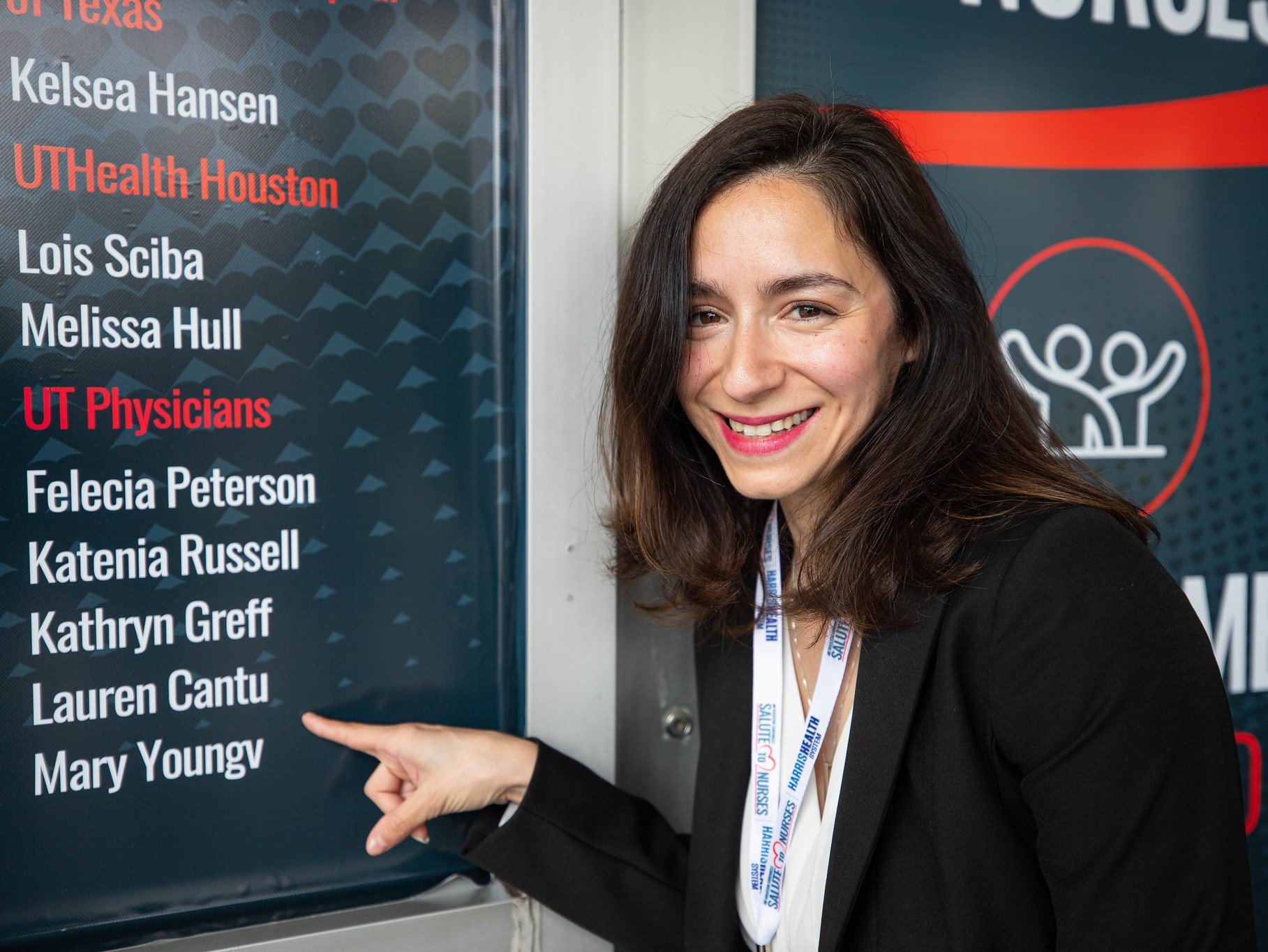 Lauren Cantu, RN, points to her name at the Houston Chronicle 'Salute to Nurses' event, where she and other UTHealth Houston nurses were honored. (Photo by Logan Ball/UT Physicians)