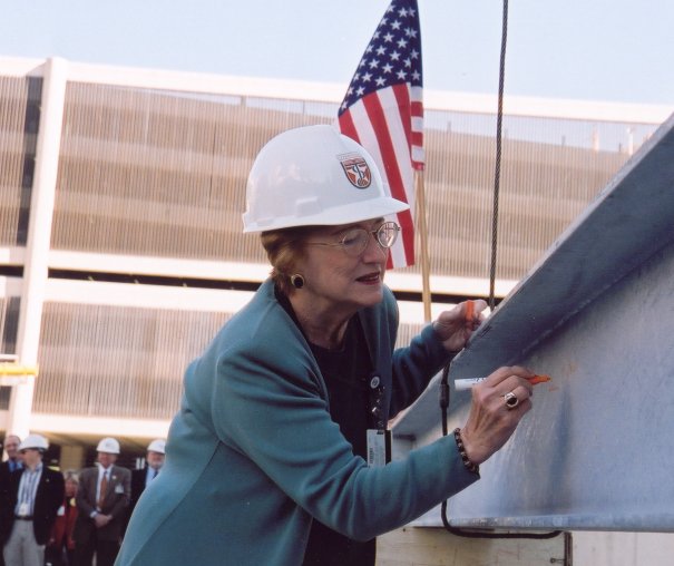 Patricia L. Stark signs a beam during construction of what would become the home of Cizik School of Nursing.