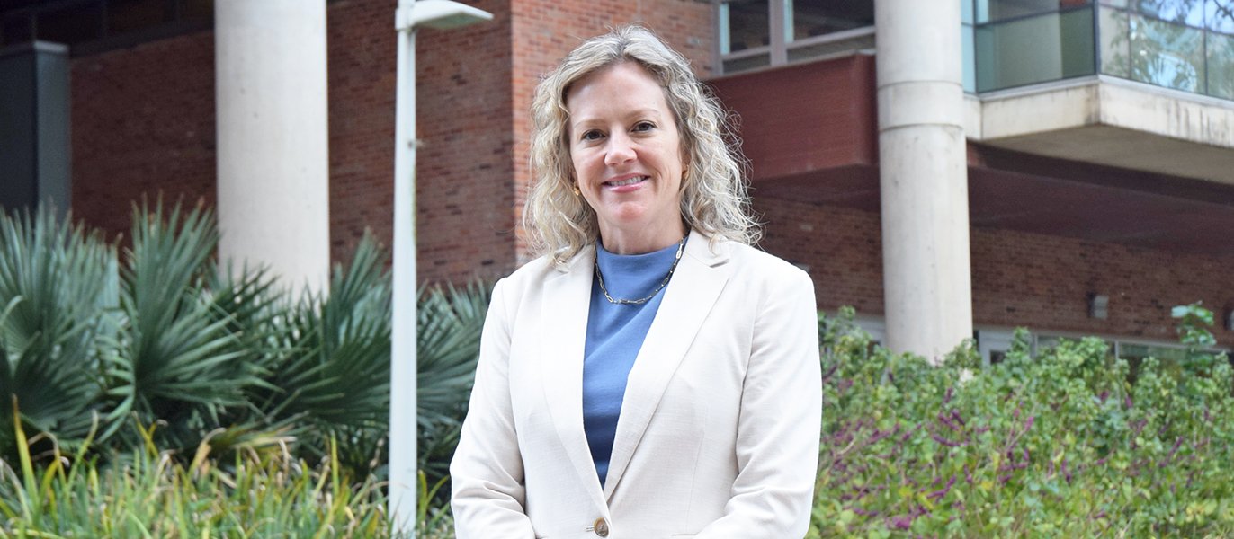 Dean Diane Santa Maria in front of Cizik School of Nursing building.