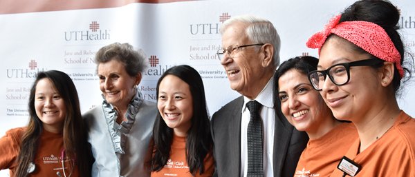Jane and Robert Cizik pose with students in 2017.