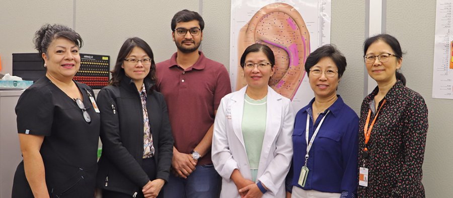 Dr. Chao Hsing Yeh (in white coat) poses with her research team
