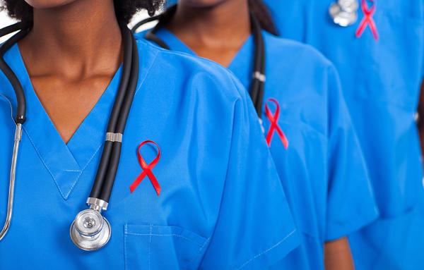 Nurses wearing red ribbons for HIV awareness, courtesy Getty Images