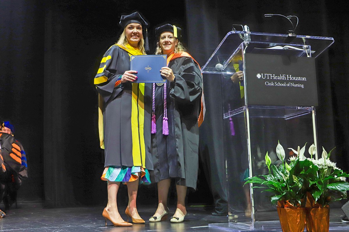 Dean Diane Santa Maria (right) presents the McGovern Graduate Teacher of the Year Award to Amy Blok.