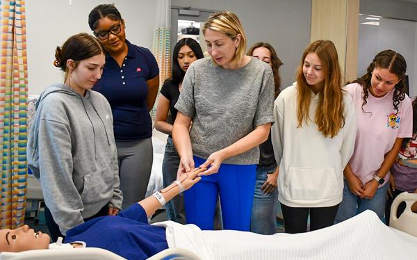 Maja Djukic with summer camp students in the Cizik School of Nursing sim lab.