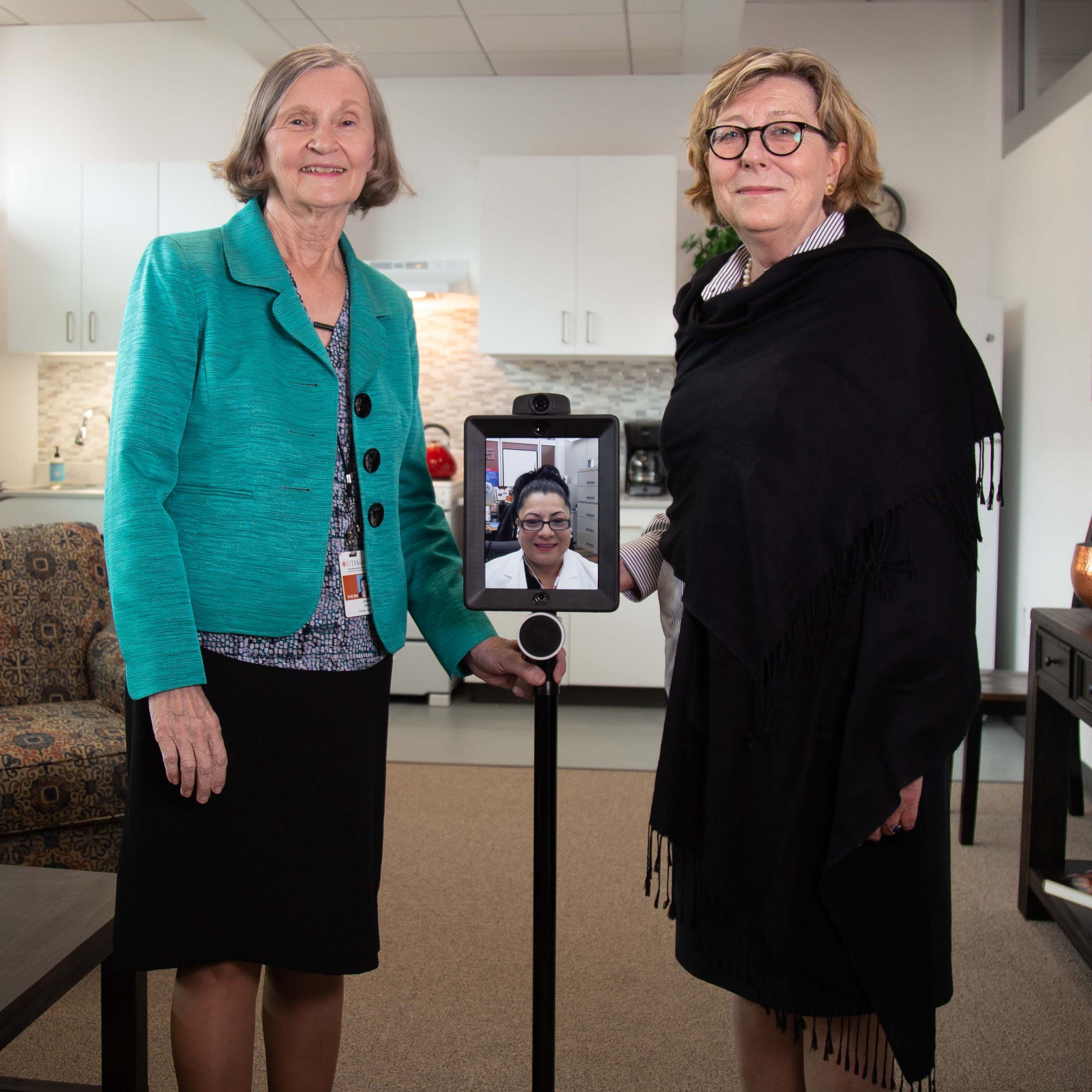 Cizik School of Nursing at UTHealth professors Joanne Hickey, PhD, RN, and Constance Johnson, PhD, RN, demonstrate robotic monitoring technology in the Smart Apartment.