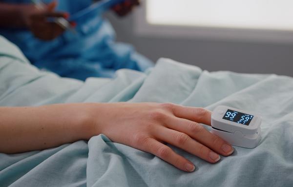 Photo of patient's hand with pulse oximeter, courtesy Getty Images.