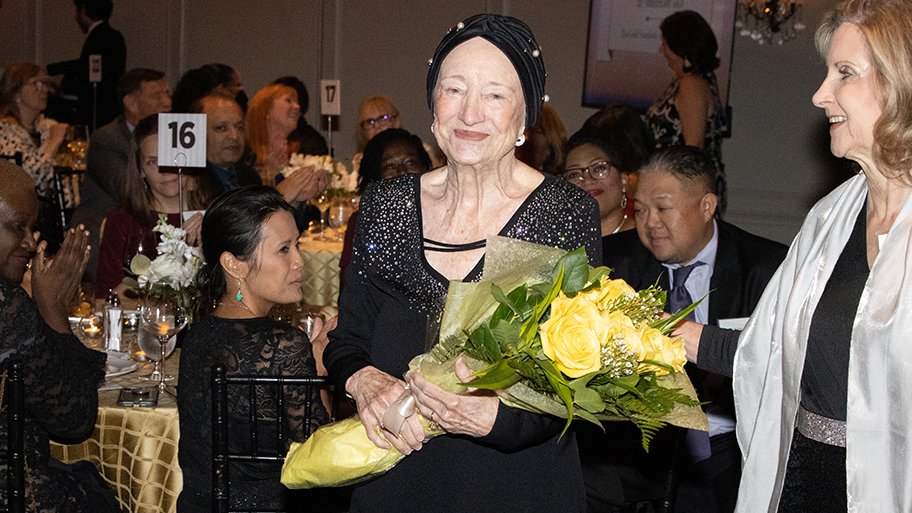 Dean Emerita Patricia Starck receives roses from Dr. Rozmus.