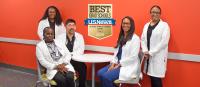 A group of family nurse practitioner students before class. The badge on the photo reads 