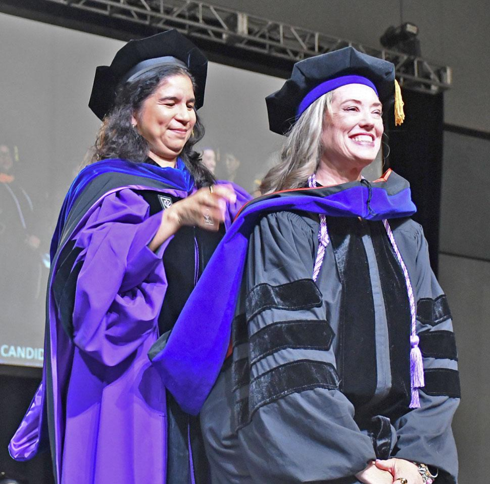 A PhD student was hooded by her academic advisor, Dr. Carina Katigbak.