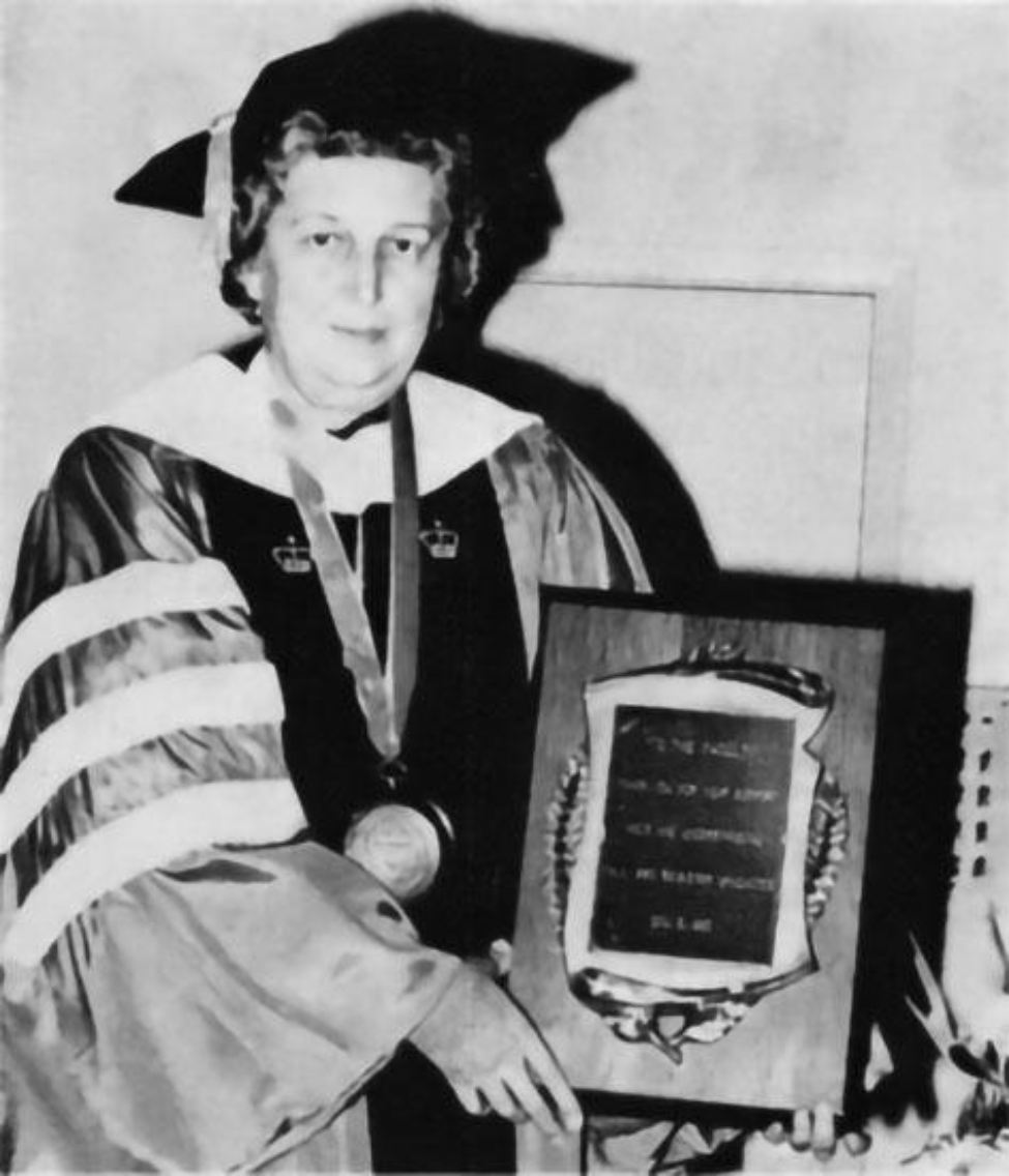 Dr. Arlowayne Swort, dean of the School of Nursing, poses with a plaque in February 1981.