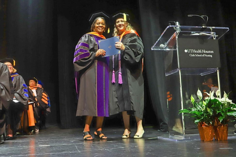 Dean Diane Santa Maria (right) presents the John P. McGovern Undergraduate Teacher of the Year Award to Hildreth Eloi.