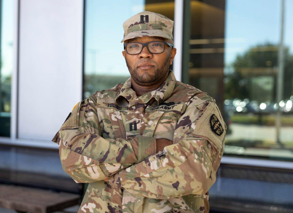 Heston Young, DDS, poses with his arms crossed while wearing his U.S. Army uniform.