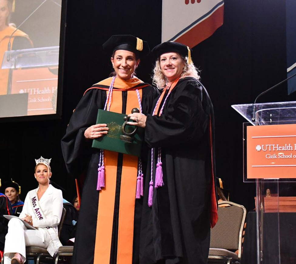Dr. Mitzy Kobeissi receiving the DAISY Award from Dean Santa Maria. Dr. Mitzy Kobeissi receiving the DAISY Award from Dean Santa Maria.