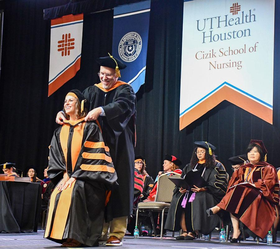 Dr. Myron H. Arnaud is hooding a DNP student. Dr. Myron H. Arnaud is hooding a DNP student.